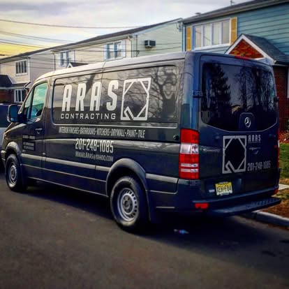 Aras Contracting work van parked on a residential street